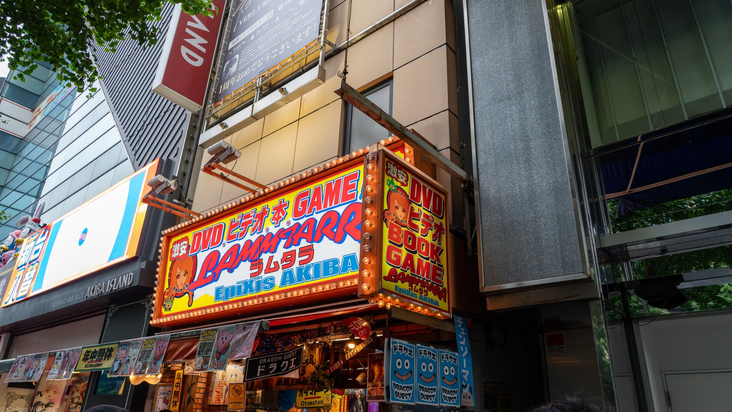 Stacked neon game and DVD shop signs in Akihabara